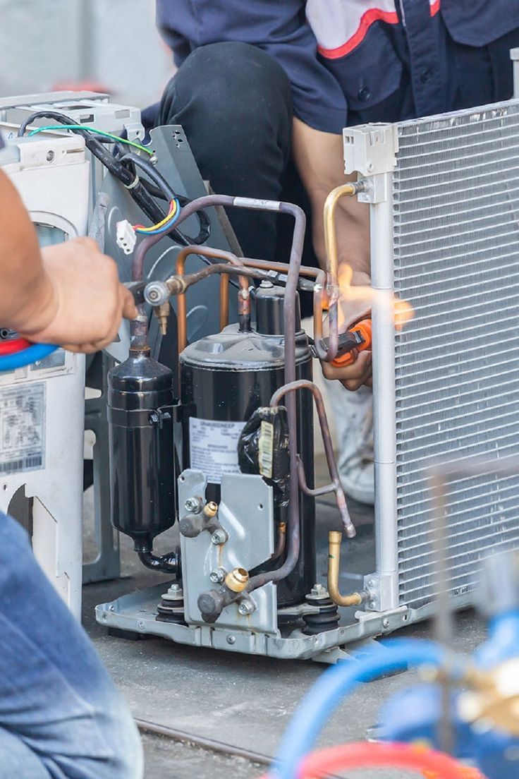 Close-up repair work on air conditioning components